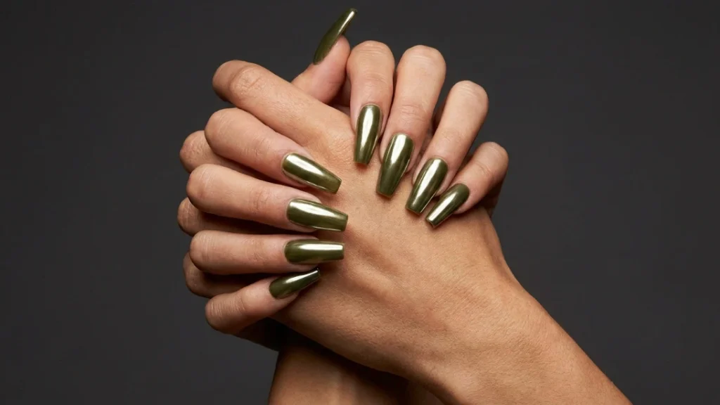 Hands showing a long coffin-shaped acrylic set in olive chrome to illustrate structural durability