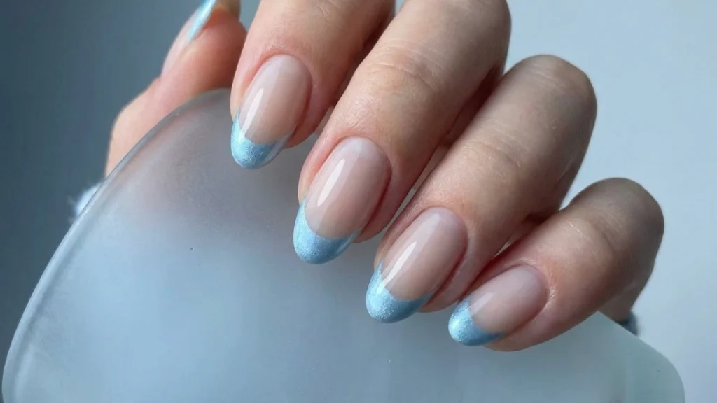 colored french tips - icy blue tip manicure over sheer base