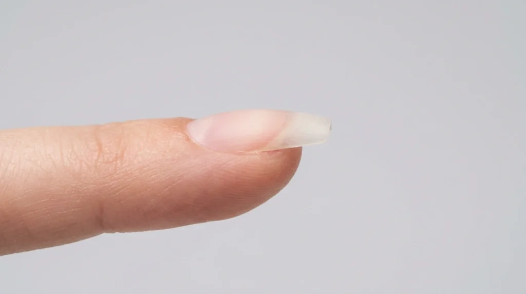 Side profile of a bare short coffin nail shape showing the flat tip and tapered sides