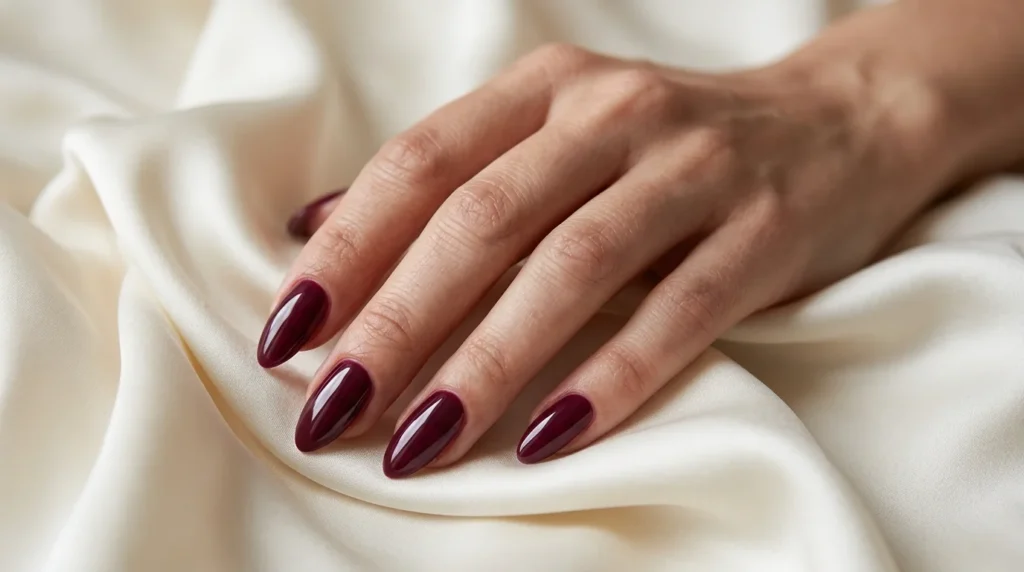 Burgundy almond nails with a tapered shape and glossy deep wine-red finish