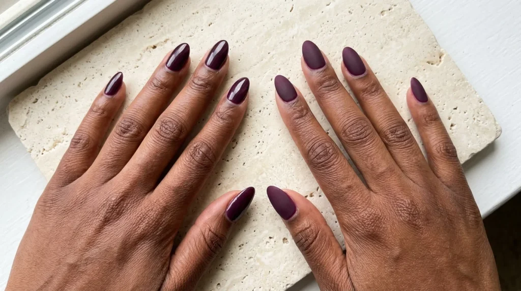 Glossy and matte plum nails side by side on dark skin
