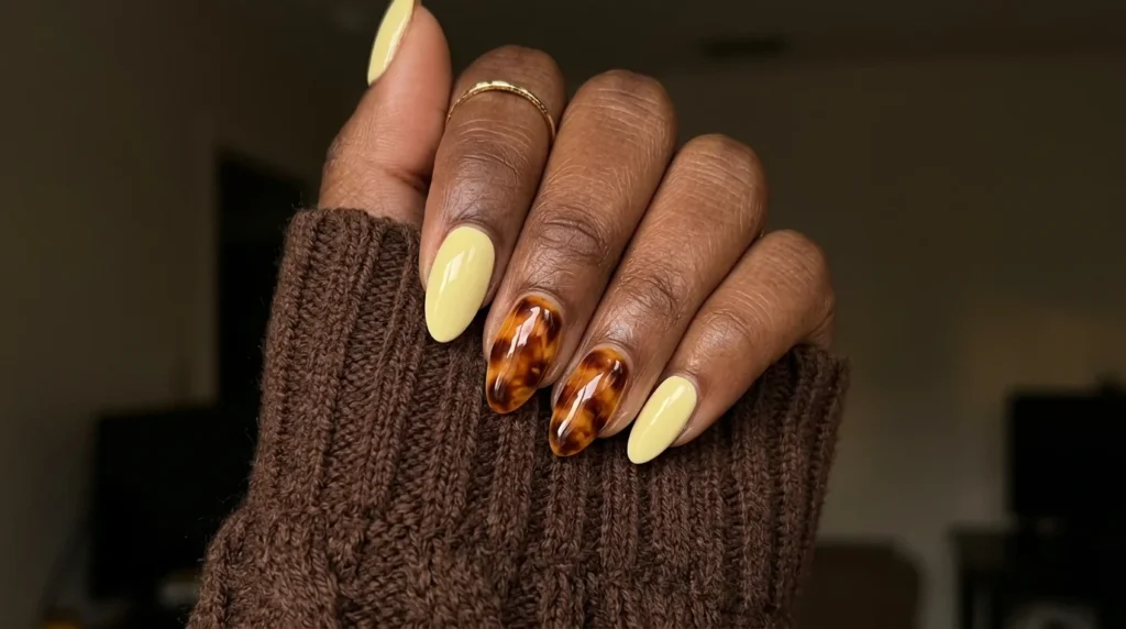 Pale yellow nails with amber tortoiseshell accent nails